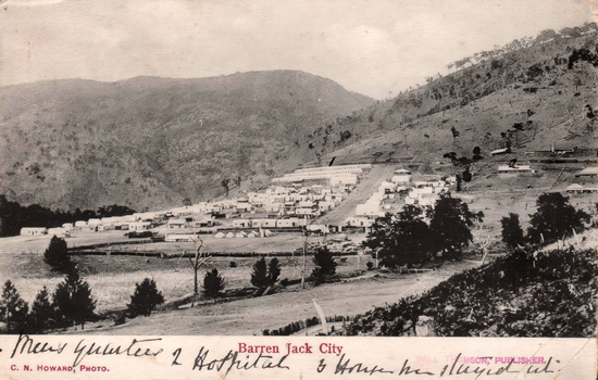This black-and-white card shows a settlement in a mountainous valley; on the card is printed “Barren Jack City”, “C. N. HOWARD, PHOTO.” and “WILL THOMSON, PUBLISHER.” The handwriting appears to read: “1 Mess Quarters 2 Hospital 3 House he stayed in.”