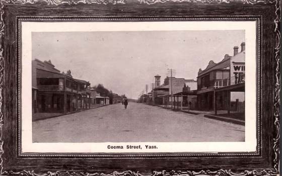 This black-and-white card shows a broad commercial street lined with shops and verandahs; on the card is printed “Cooma Street, Yass.”