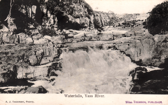 This black-and-white card shows a waterfall flowing through a rocky river gorge; on the card is printed “Waterfalls, Yass River.”, “A. J. SHEARSBY, PHOTO.” and “WILL THOMSON, PUBLISHER.”