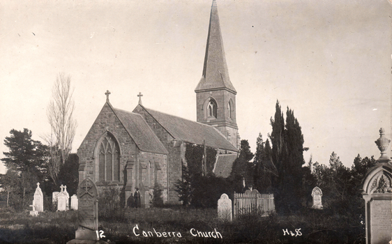 This black-and-white card shows a stone church with a tall spire and surrounding graveyard; on the card is printed “12 Canberra Church H&S”.