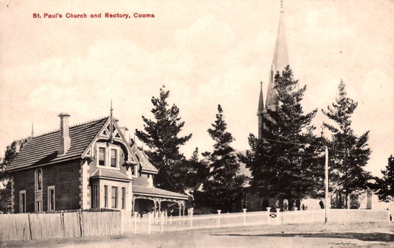 This black-and-white card shows a church and adjoining rectory behind trees and a picket fence; on the card is printed “St. Paul’s Church and Rectory, Cooma”.