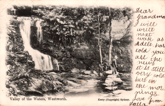 This black-and-white card shows a waterfall flowing through a wooded valley: On the card is printed “Valley of the Waters, Wentworth. Kerry (Copyright) Sydney.” The handwriting reads: “With love from Stella. I hope you will like this. Will write next week.”