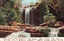 This coloured card shows a waterfall cascading through a rocky, wooded landscape: On the card is printed “WATERFALL—NATIONAL PARK, NEW SOUTH WALES.”
