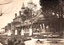 This black-and-white card shows nurses and a man standing in the gardens outside a large brick hospital: On the card is printed “Forbes Hospital. HOWE PHOTO FORBES.”