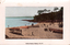 This coloured card shows a beach with small boats and people along the shore; on the card is printed “Shelly Beach, Manly, N.S.W.”