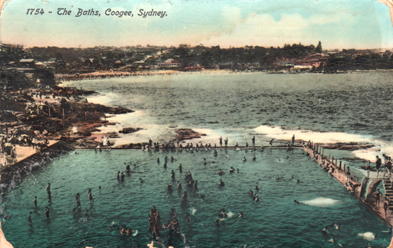 This coloured card shows an ocean swimming pool crowded with bathers beside Coogee Beach; on the card is printed “1754 - The Baths, Coogee, Sydney.”