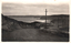 This black-and-white card shows motor cars travelling along a coastal road overlooking the sea; on the card is printed “Memorial Drive Newcastle”.