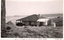 This black-and-white card shows a seaside cottage overlooking the coast; on the card is printed “Seaside Cottage at Tuross Heads, South Coast” and “(Copyright.)”.