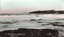This coloured card shows a rocky ocean shoreline with a distant headland: On the card is printed “10. PORT HACKING HEADS, N.S.W LOOKING SOUTH. COPYRIGHT.”