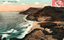 This coloured card shows a coastal beach beneath steep hills: On the card is printed “1797 ~ Stanwell Park.”