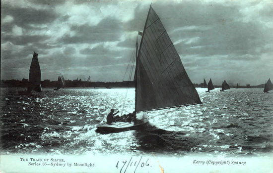 This coloured card shows sailing boats on a harbour, with a large yacht in the foreground: On the card is printed “THE TRACK OF SILVER. Series 35—Sydney by Moonlight. Kerry (Copyright) Sydney”.