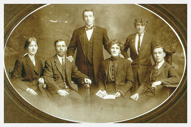lack and White photo of Family of Charles and Ellen Reynolds (presumed sitting 2nd and 3rd from the left), about 1915, with their family, Amelia, Robert, Louisa and Hector.