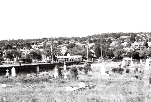 11147.6j The Quarry Hill tram passes the Carpenter and Houston St intersection at the corner of the cemetery