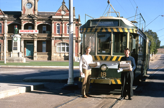 11147.9o No 18 at Eaglehawk, Bendigo T.M.S of Vic. Ltd Photo, Sat 15 April 1972. Robert Green and John Fitzsimons holding "Last Tram Mail" 1/125 f8. Taken at 9am on the second last day of the trams.
