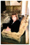 Colour photo of Lorainne Isaacs of Valentines, Furniture and Auctions, enjoying the luxurious set of the lounge chairs and sofa.