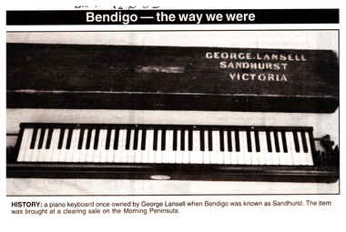 Black and White  photo of a piano keyboard with engraving on the top