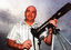 11217.33b Colour Photo of Russel Henthorn with his camera and gear he used for a UFO photo in 1983