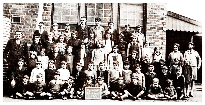 Black and white photo of the class of 1930 at Marong Primary School with two of the Lansell descendants.