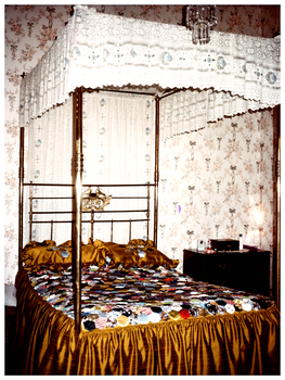 Colour photo 7.5 x 10 inches of four poster bed at "Myrtle House", Bendigo. The photo is of the elegant four-poster bed in which nine of Wotton Lansell's grandchildren - the family of his son Thomas William, were born. On the rear of the photo is written in ink. "Main bedroom, Myrtle Villa c 1982; a gift to Wotton and Helen Lansell from Edith Lansell."