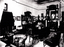 Black and White photo of a living room with chairs and small table
