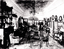 Black and White photo of the living room, the walls adorned with painting and photographs