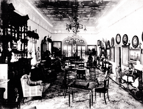 Black and White photo of the living room, the walls adorned with painting and photographs