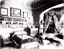 Black and White photo of the family bedroom, with a child's bed and a large four-poseter with curtains