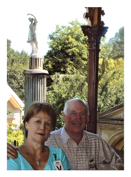 Colour photo of Helen and John McEwen with the statue in the background
