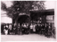 An A4 Black and white print of presumably the Boltons Staff outside of their shop in Centre Way Mitchell Street Bendigo possibly in the 1920s, a large group of people and two men with bicycles.
