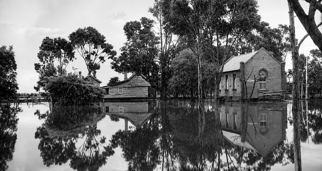 Black and white photo of the Bagshot State School grounds after Bendigo Creek had flooded, taken in the late 1920s, early 1930s