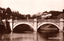 This black-and-white card shows a stone arched bridge across a moat with palace buildings in the background: On the card is printed “301 Imperial Palace, Tokyo.”