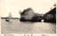This black-and-white card shows a small sailing boat beside a rocky island with a natural arch: On the card is printed “View of Matsushima.
The Japanese is printed in the older right-to-left direction. Read normally, it translates as:
沈石島 — “Sunken Rock Island.”
松島百景 — “One Hundred Views of Matsushima.”