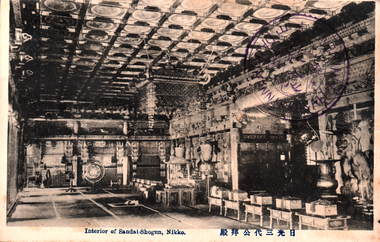 This black-and-white card shows the richly decorated interior of a shrine hall. On the card is printed “Interior of Sandai-Shogun, Nikko”. The Japanese 日光三代公拜殿 translates as “Worship Hall of the Third Shogun, Nikkō.”
