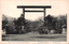 This black-and-white card shows a large torii gate at the entrance to a shrine. On the card is printed “The Yasukunjija Shrine Tokyo". The Japanese is printed from right to left and reads 九段靖國神社（東京名所）, translating as “Yasukuni Shrine at Kudan (a famous place in Tokyo).”