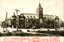 his black-and-white card shows a large civic building with a prominent central clock tower. On the card is printed “The Civil Administration Office, Dairen.” together with a Japanese description in red. The Japanese is printed in the traditional right-to-left direction. The main text begins:
大連民政署（満州）はもとダルニー市廳跡を修繕して創設の事務を執り… and continues by describing the office moving to the Dairen Club, then to a newly constructed government building at the Great Square, and the subsequent development of the surrounding area.