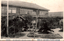 This black-and-white card shows a large Japanese school building and its landscaped garden. On the card is printed “ THE KASHIWAZAKI HIGER GIRLS' SCHOOL, NIIGATA. The Japanese is printed right-to-left. Read in modern order, the main caption is: 新潟縣立柏崎高等女學校本校々舎玄關前 Modern characters: 新潟県立柏崎高等女学校本校校舎玄関前 English translation: “In front of the main school building of Niigata Prefectural Kashiwazaki Higher Girls’ School.” The smaller Japanese wording reads: 庄川雜貨店
English translation: “Shōgawa General Store.”