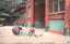 This coloured card shows a woman and two children beside a temple building, with birds on the ground. On the card is printed “(D:1)”, “Temple Hachiman at Kamakura.” The Japanese translates as “Hachiman Shrine at Kamakura” (referring to Tsurugaoka Hachimangū, Kamakura).