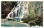 This coloured card shows a waterfall descending over a rocky cliff into a pool surrounded by vegetation. On the card is printed “Tamadare Waterfall at Yumoto, Hakone.” and “箱根湯本玉簾ノ瀧”. The Japanese 箱根湯本玉簾ノ瀧 translates as “Tamadare Waterfall at Yumoto, Hakone.”