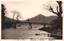 This black-and-white card shows a bridge crossing a lake or river with mountains beyond. On the card is printed “UTAGAHAMA AT NIKKO”, “歌の濱ヨリ二荒山遠望” and “（日光名所）”. The Japanese translates as:
歌の濱ヨリ二荒山遠望 — “Distant view of Mount Futara from Utagahama”
日光名所 — “Famous places of Nikkō”