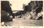 This black-and-white card shows a river gorge with steep rocky cliffs and a bridge in the distance. On the card is printed “THE TENRYUKYO, SHINANO.”, “天龍峽”, “（信濃八景）” and “（河原書店版）”. The Japanese translates as:
天龍峽 — “Tenryū Gorge”
信濃八景 — “Eight Views of Shinano”
河原書店版 — “Kawahara Bookshop edition”