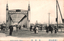 This black-and-white card shows a large iron bridge with pedestrians and vehicles. On the card is printed “AZUMA BLIDGE TOKYO”, “吾妻橋” and “（東京名所）”. The Japanese translates as:
吾妻橋 — “Azuma Bridge”
東京名所 — “Famous places of Tokyo” / “Tokyo sights”