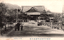This black-and-white card shows a large shrine or temple building at the end of a broad approach path, with an adult and two children in the foreground. On the card is printed “HOSAIKAI, IN ISE.” and “伊勢神宮奉齋會本部”. The Japanese translates as:
伊勢神宮奉齋會本部 — “Headquarters of the Hōsaikai of Ise Jingū” / “Headquarters of the Ise Shrine devotional association”