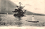 This black-and-white card shows small sailboats on a lake beside a tree-covered islet, with hills behind. On the card is printed “Kozukejima Chuzenji Lake, Nikko.” and “日光中禅寺湖上野島”. The Japanese translates as:
日光 — “Nikko”
中禅寺湖 — “Lake Chuzenji”
上野島 — “Kozukejima” / “Kōzuke Island”
Together, the Japanese caption means: “Kozukejima on Lake Chuzenji, Nikko.”