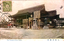 This coloured card shows the main buildings and forecourt of Tenmangū Shrine in Osaka, with lanterns and notice boards. On the card is printed “The Tenman shrine, Osaka.” and “大阪天満宮”. Japanese translation:
大阪天満宮 — “Osaka Tenmangū Shrine.”