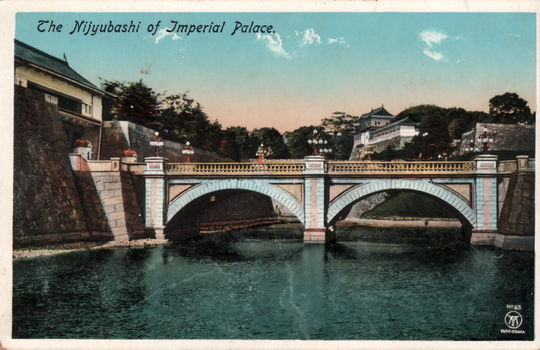 This coloured card shows a bridge over the moat at the Imperial Palace, with palace buildings and stone walls beyond. On the card is printed “The Niyyubashi of Imperial Palace.”