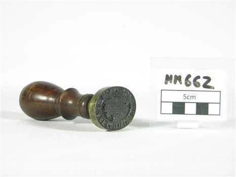 A historic stamp next to a sign with the label MM 662.