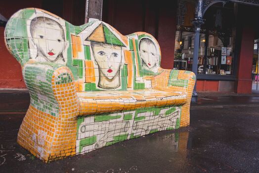 A large mosaic chair depicting three brothers.