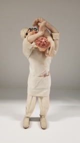 Textile - Felt and linen figurine of an obstetrician holding a baby