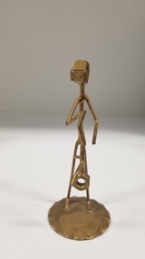 Sculpture - Metal sculpture of a figure holding a baby