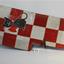 Red and silver checkered object with a cat logo